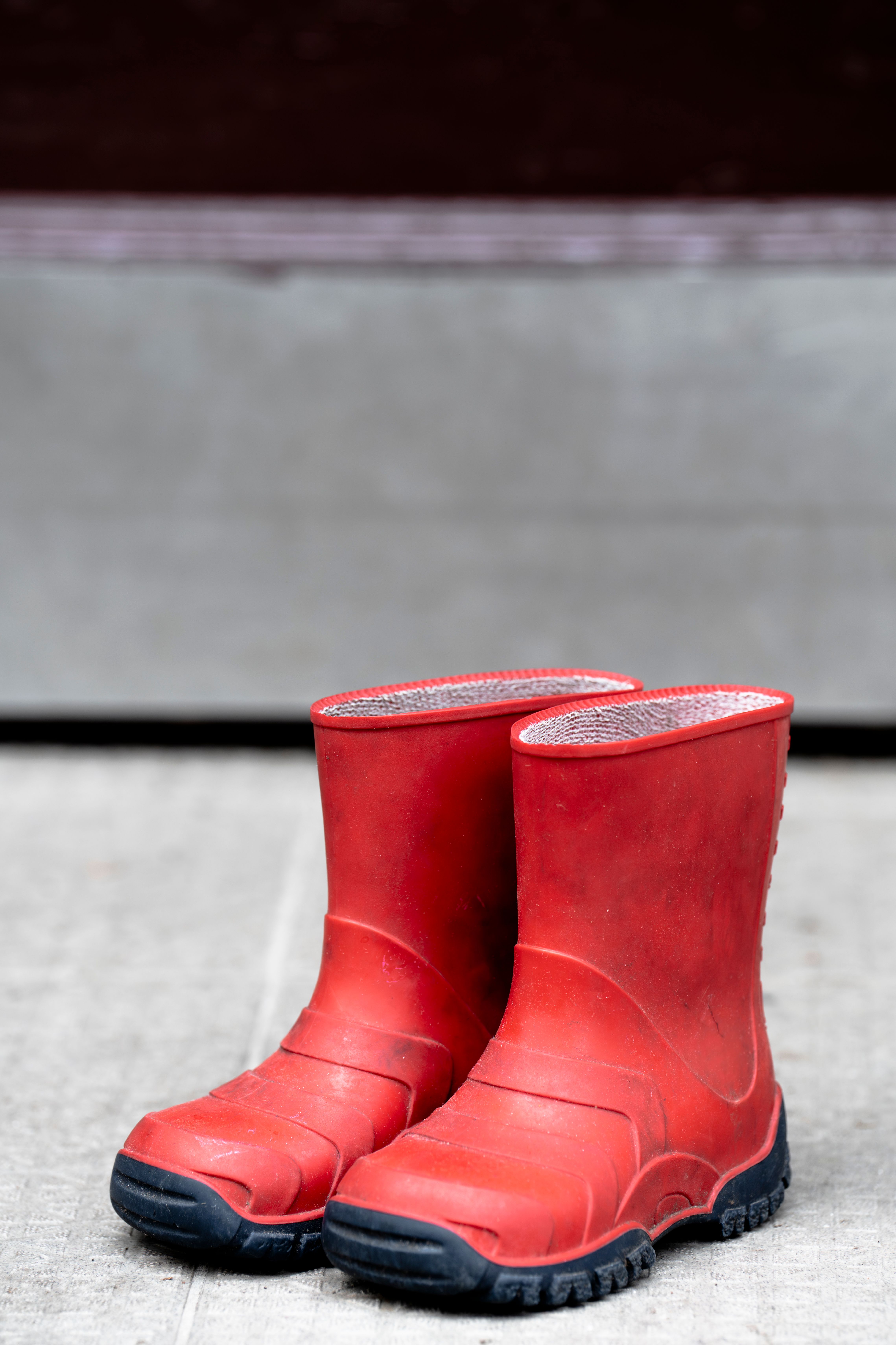 Close-up of Vibrant Red Rubber Boots Outdoors · Free Stock Photo