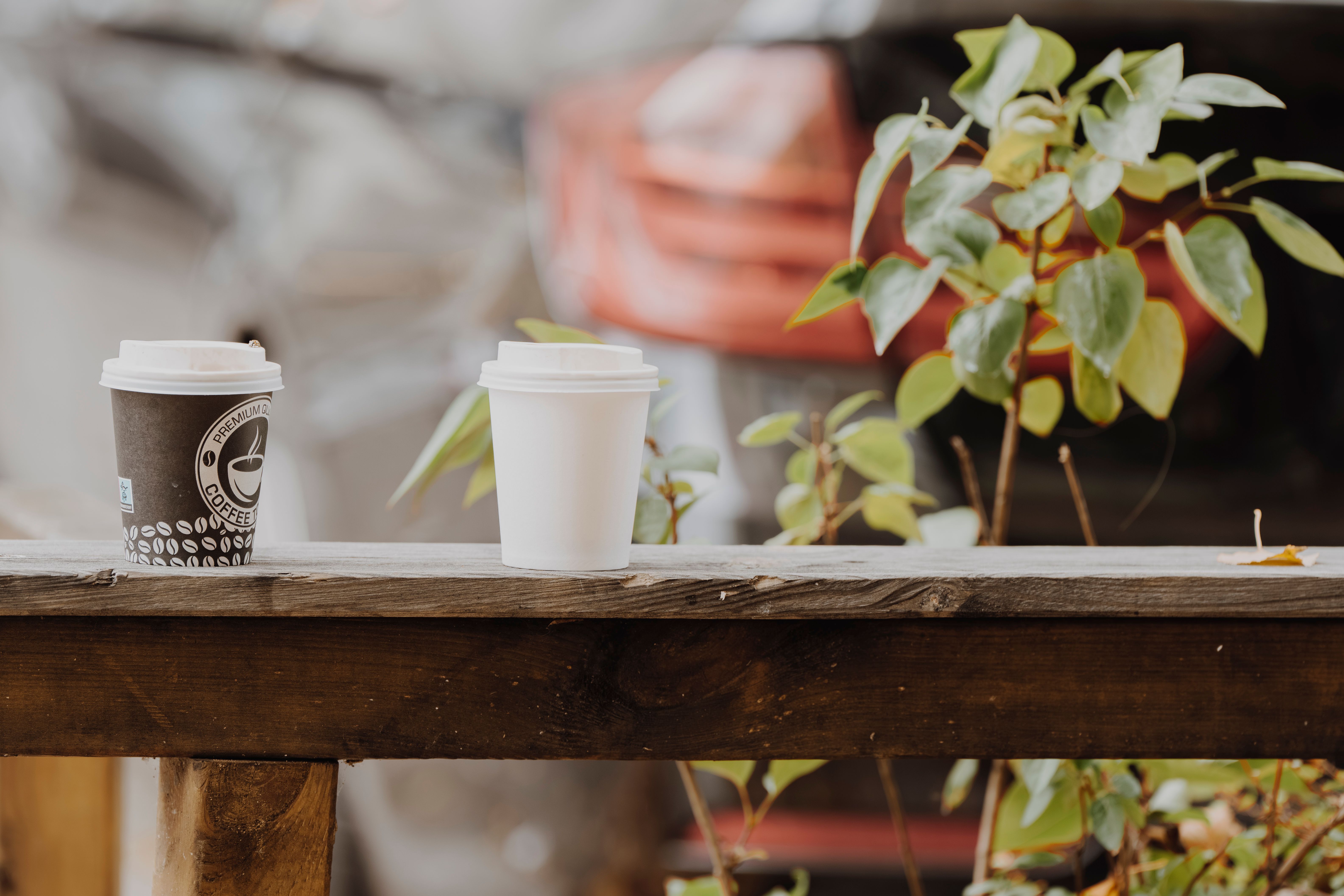 A Cup of Coffee on a Metal Railing · Free Stock Photo