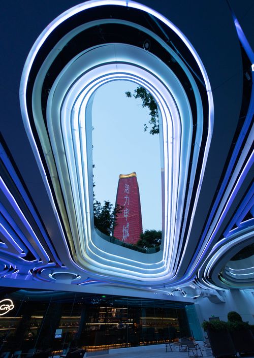 Free Stunning view of modern architecture with neon blue lights, showcasing a unique oval structure. Stock Photo