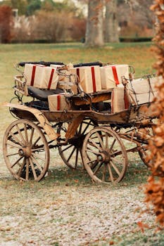 An old wooden cart outdoors filled with wrapped Christmas gifts, capturing a festive winter atmosphere.