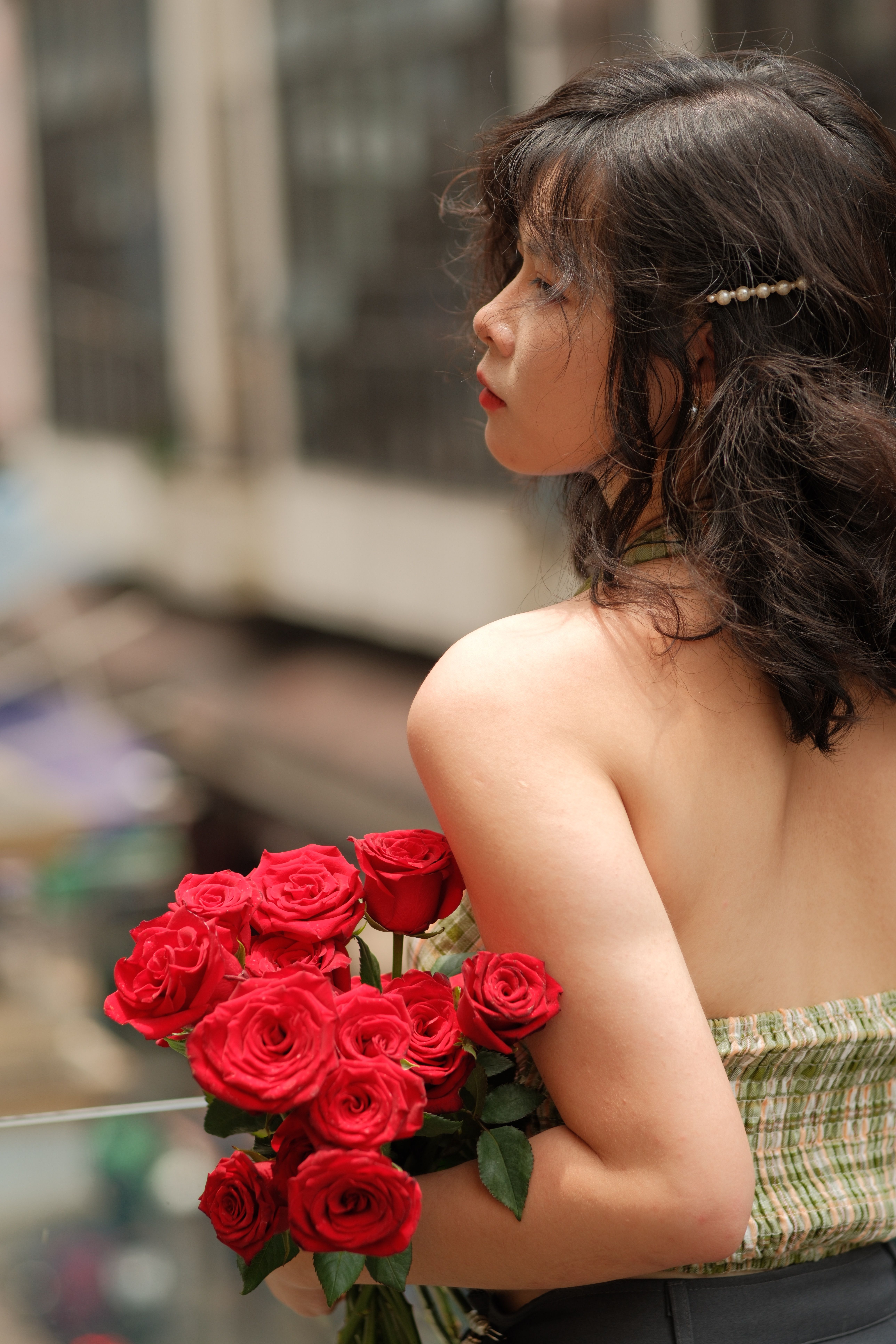 Woman Holding Red Roses in Urban Setting · Free Stock Photo