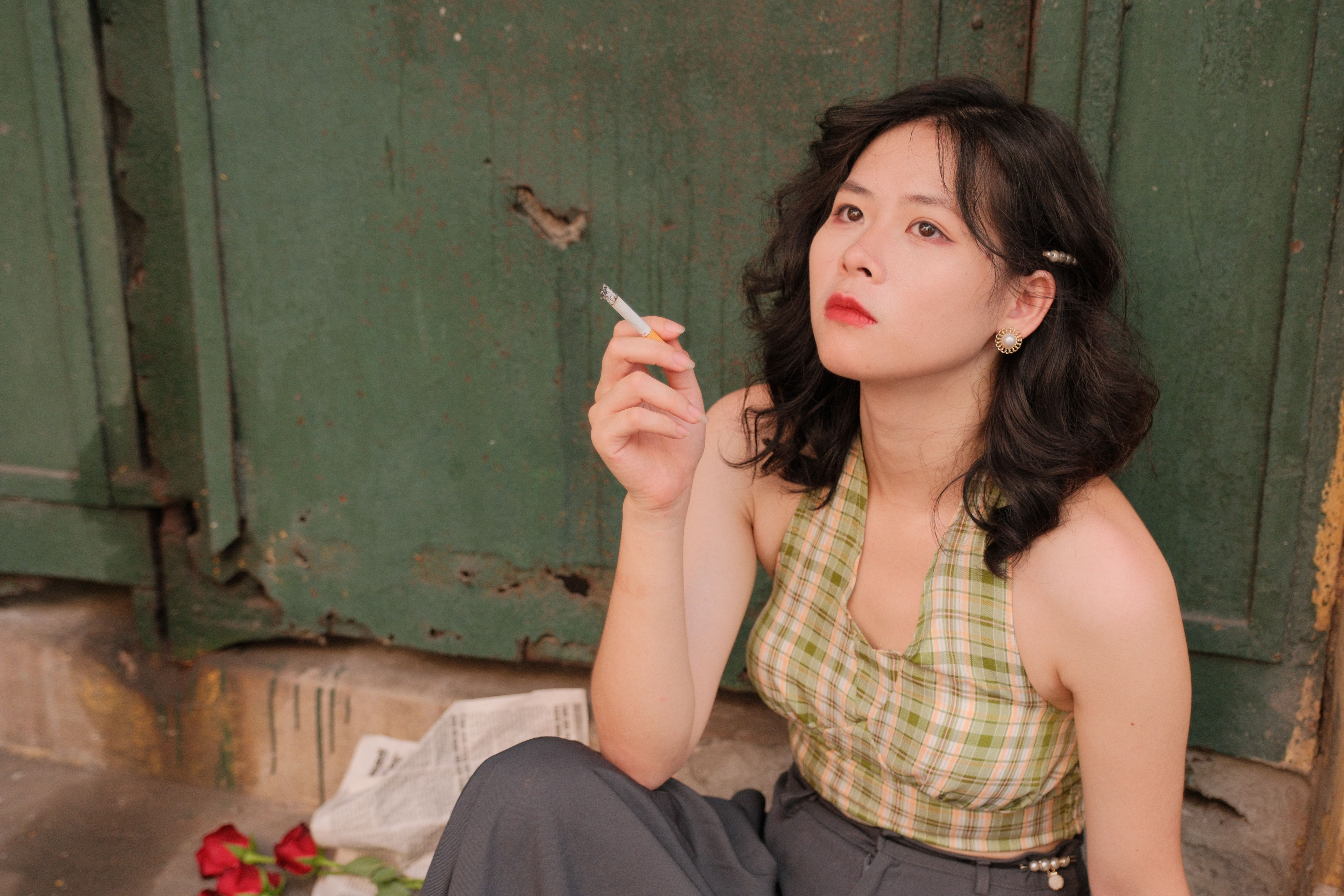 Contemplative Woman Smoking in Urban Alleyway · Free Stock Photo