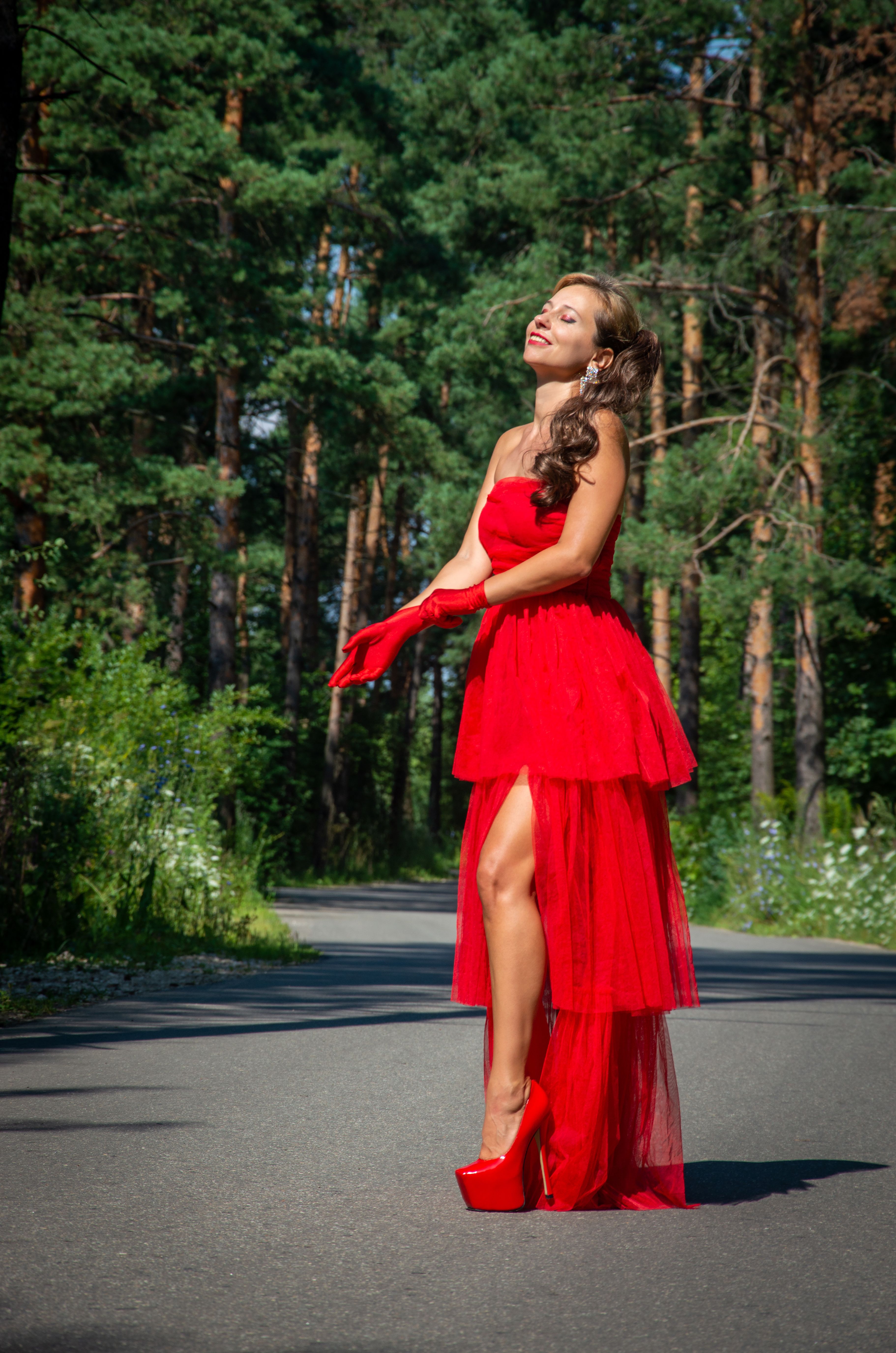 Elegant Woman in Red Dress Strolling Outdoors · Free Stock Photo
