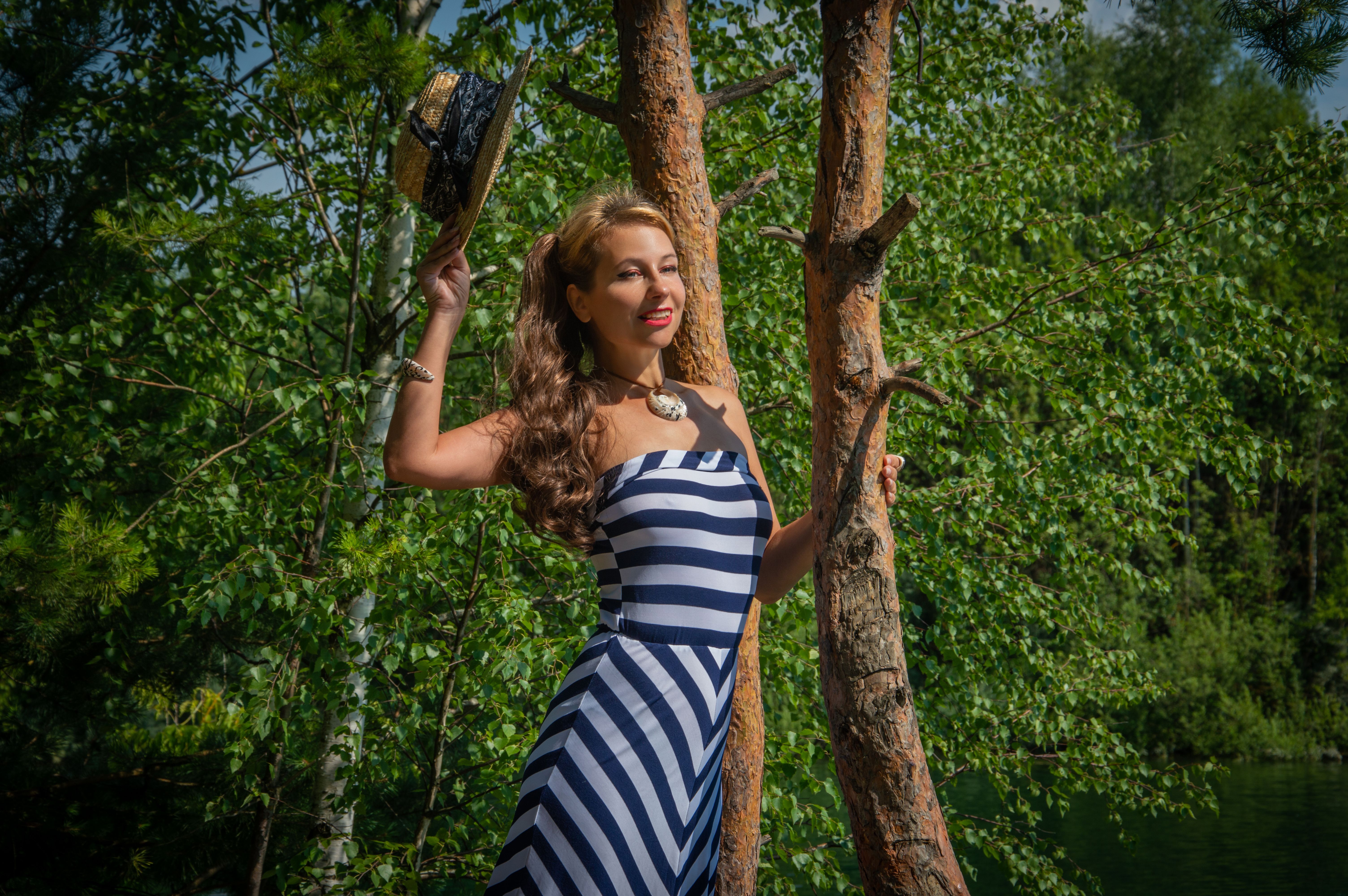 Smiling Woman in Striped Dress Outdoors · Free Stock Photo