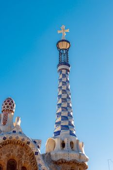 Detail of a mosaic spire in Park Güell, Barcelona, showcasing iconic Catalan architecture.