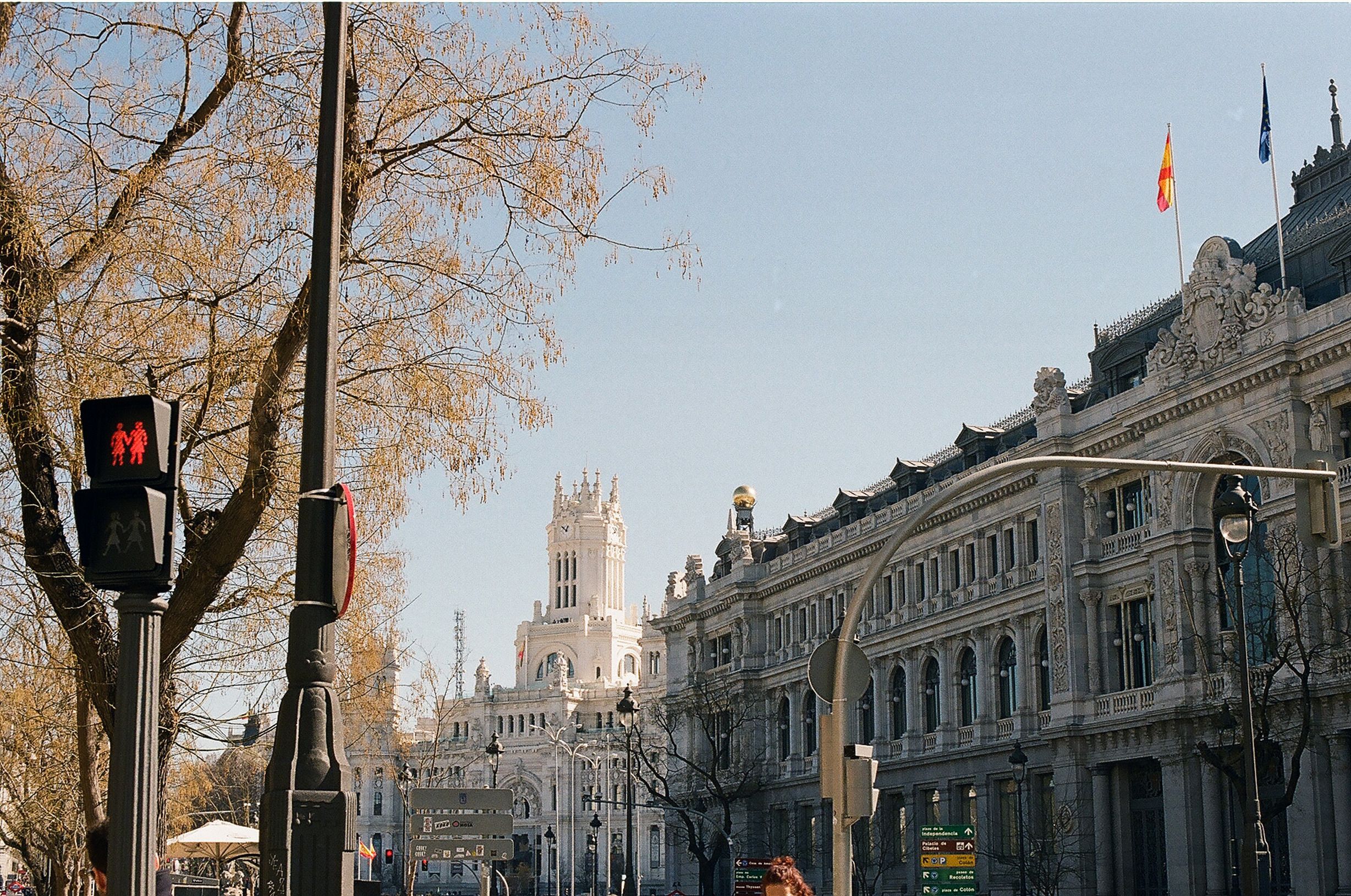 Stunning view of Madrid's historic architecture with a street scene under clear skies. — photo by Serena Alemany / Pexels