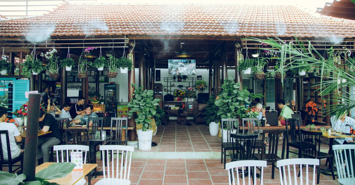 cozy neighborhood coffee shop patio with young people talking