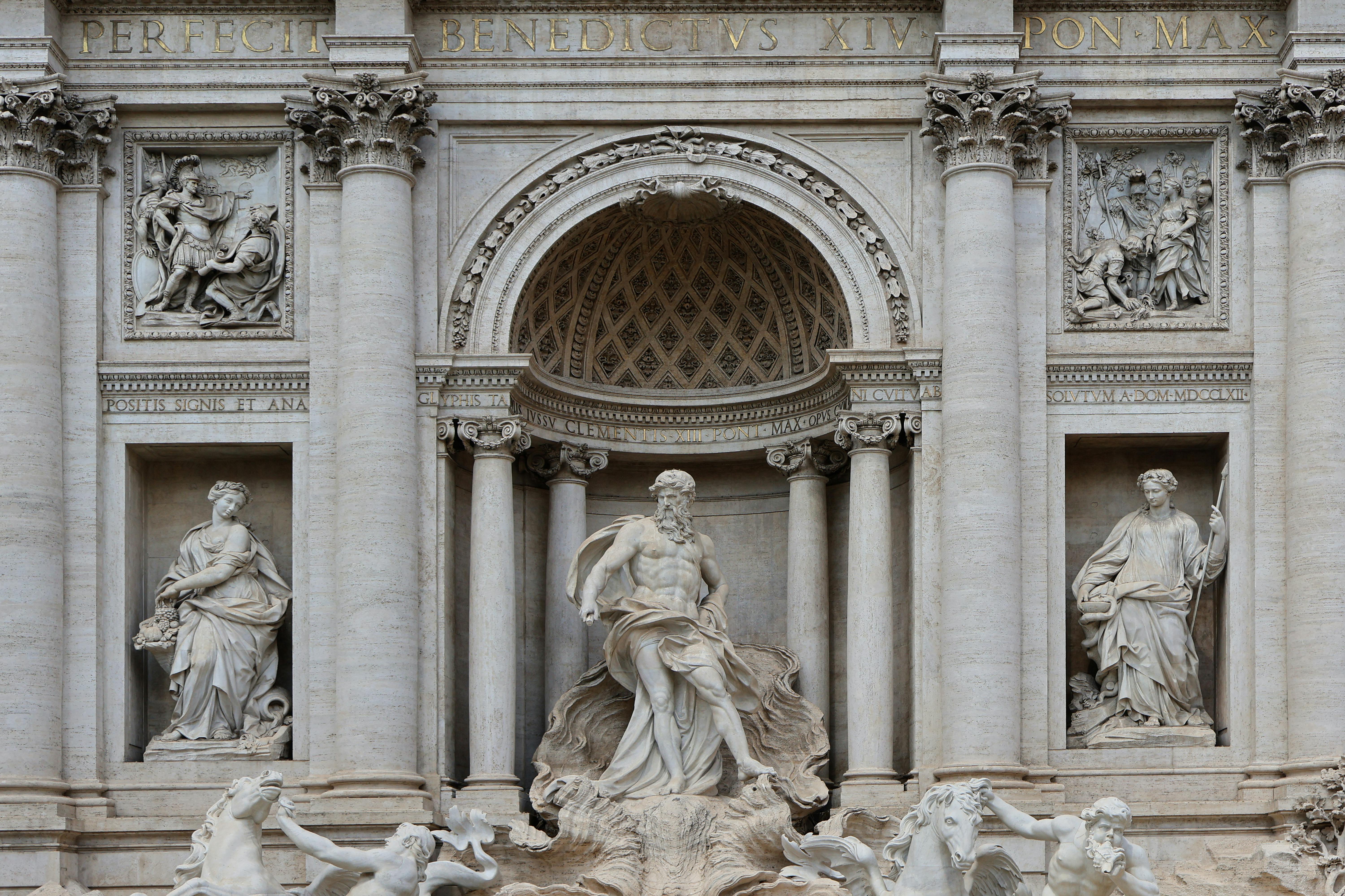 Close-up of Trevi Fountain statues showcasing classic Roman architecture and sculptures.