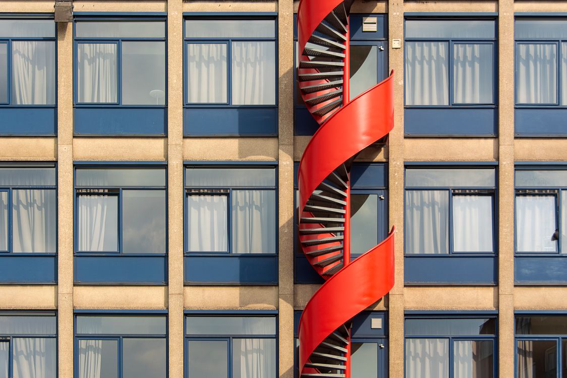 Modern Building with Red Spiral Staircase · Free Stock Photo