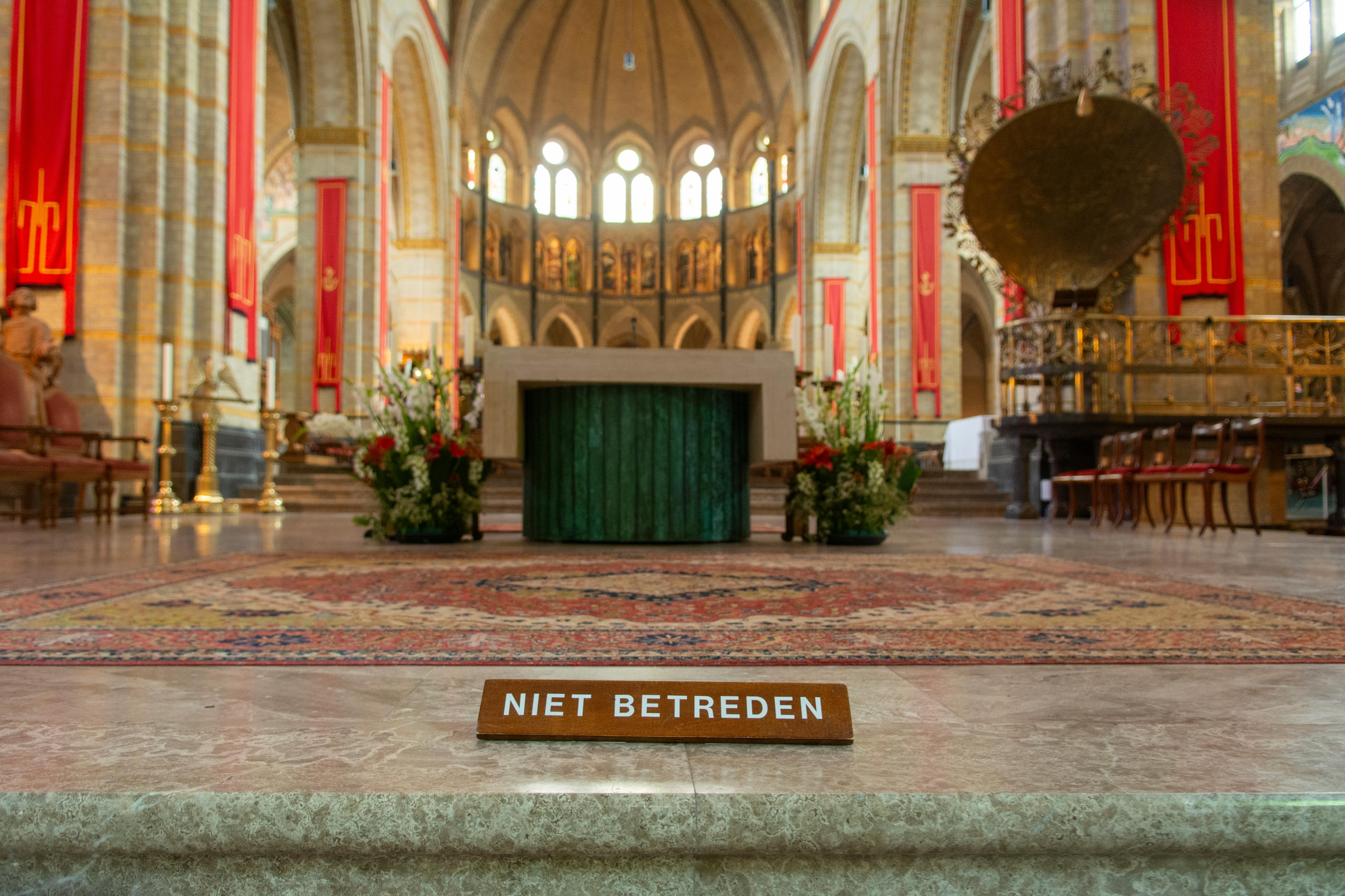 Intricate church interior featuring an ornamental altar and 'Do Not Enter' sign.
