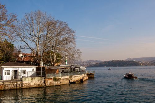 Free Charming waterfront scene at Istinye near Bosphorus with a small boat and scenic hills. Stock Photo