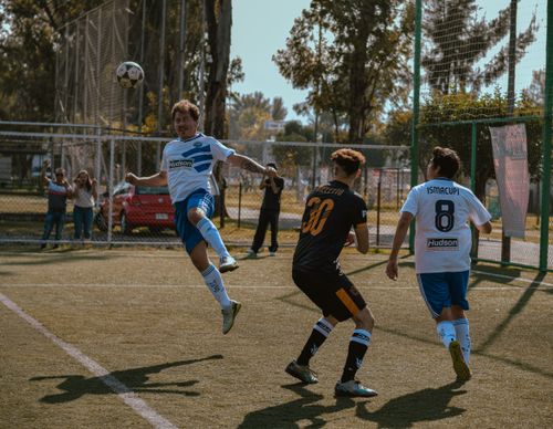 Free Exciting outdoor soccer match capturing players in action with precise movements. Stock Photo