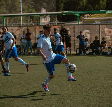 Dynamic amateur soccer game featuring young athletes playing outdoors.