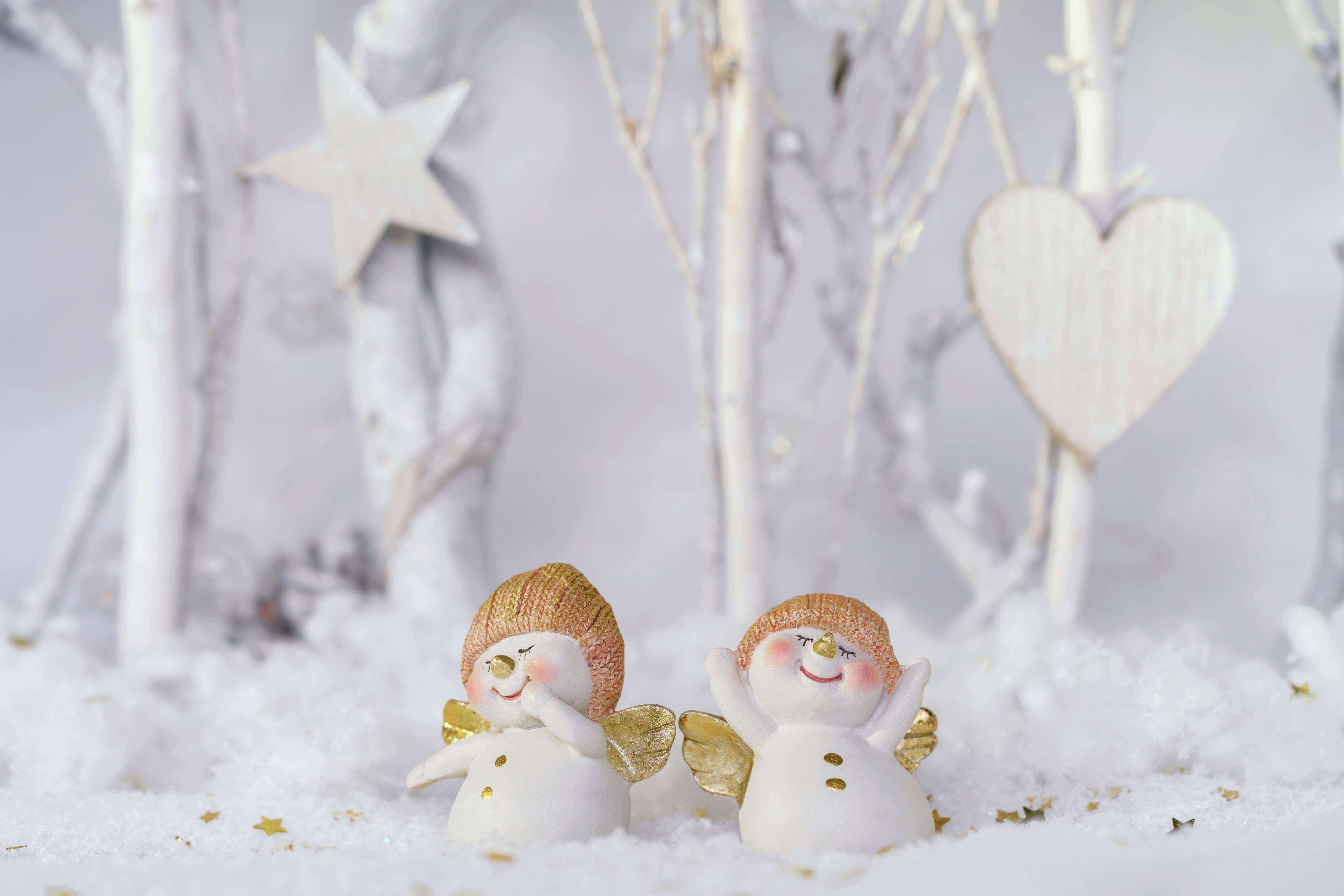 Adorable snow angels figures in a winter wonderland setting, perfect for seasonal decor.
