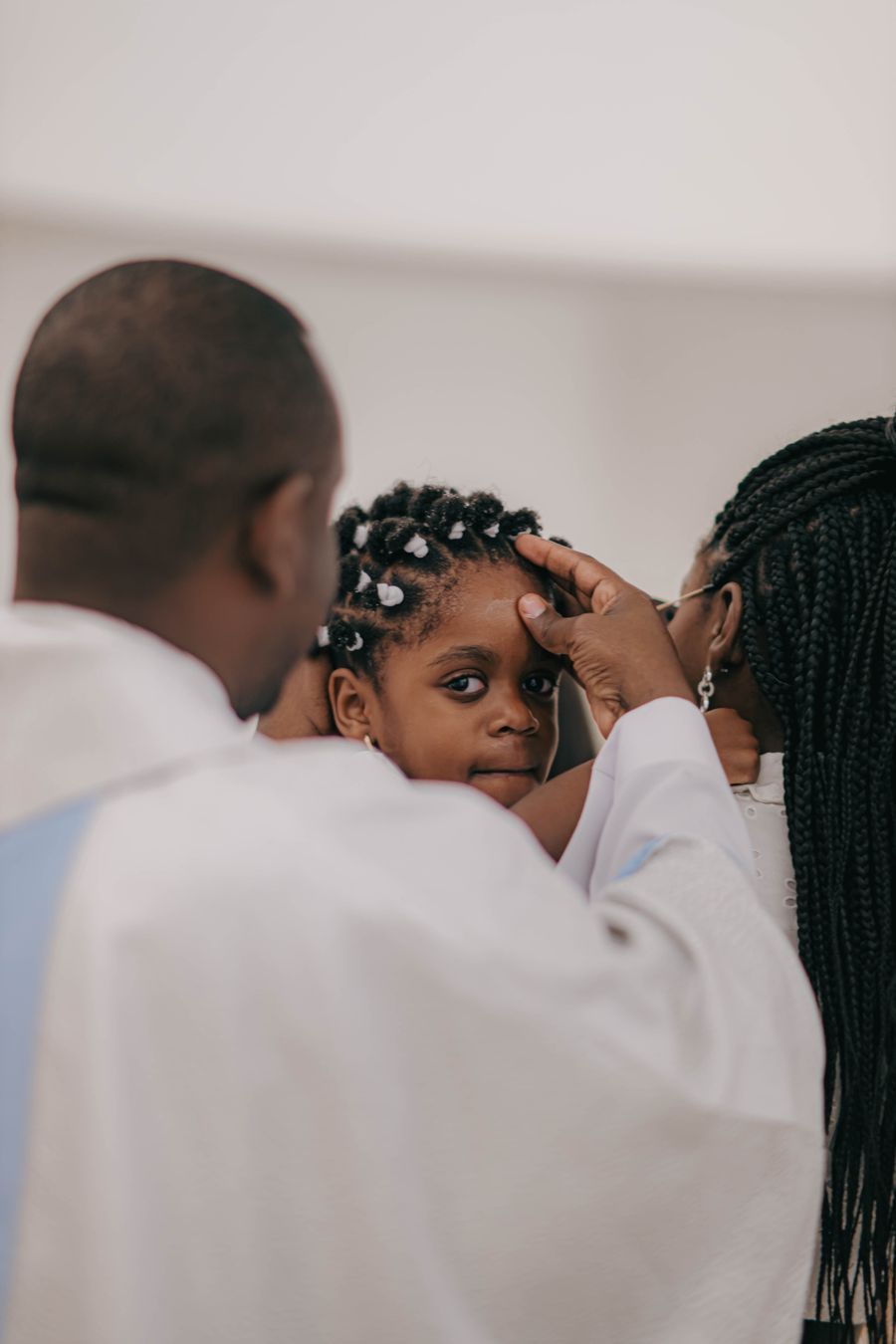 African family gathered for a child's baptism ceremony
