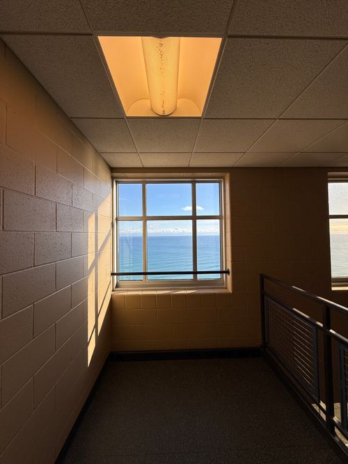 Free Captivating sea view from indoors, highlighting serene ocean scenery through a hallway window. Stock Photo