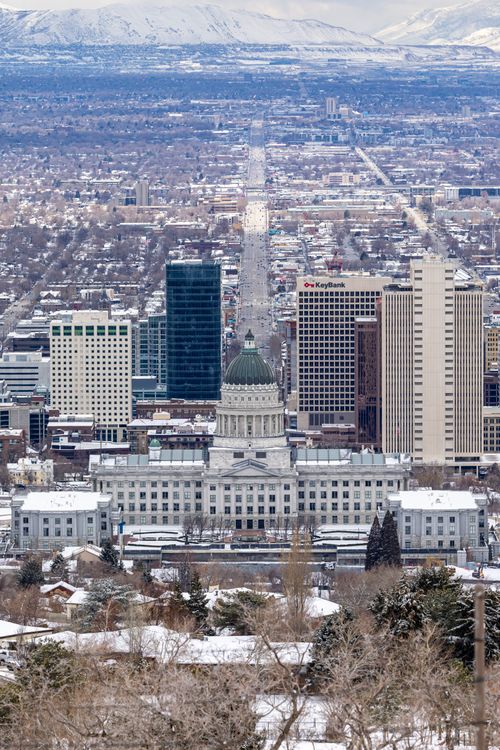Free Aerial view of snowy Salt Lake City skyline featuring the Utah State Capitol building. Stock Photo