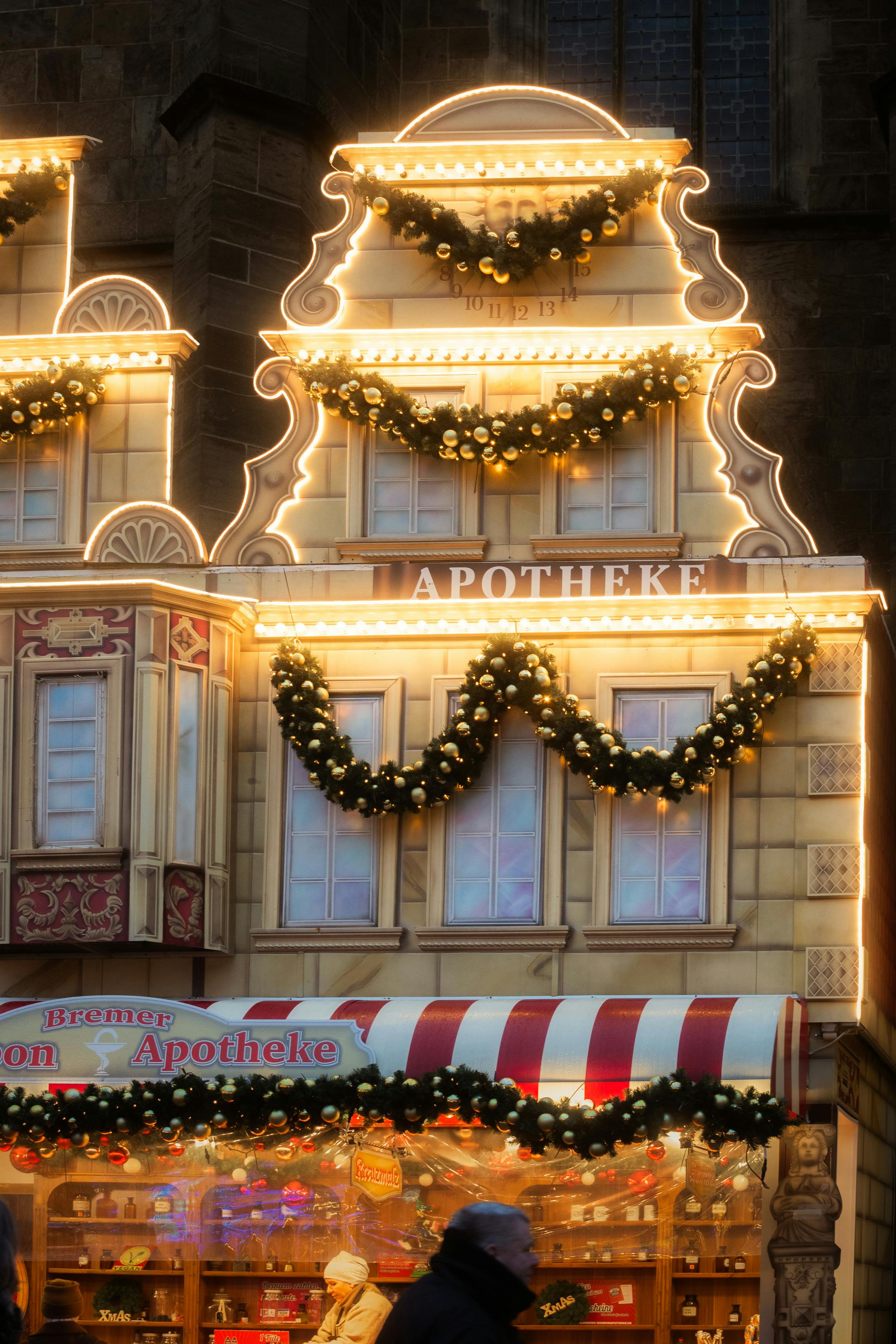 festive christmas market in bremen with illuminated apotheke