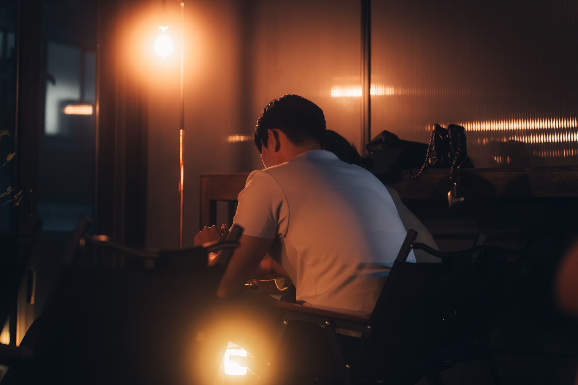 A romantic evening indoors with a couple enjoying cozy, warm lighting.