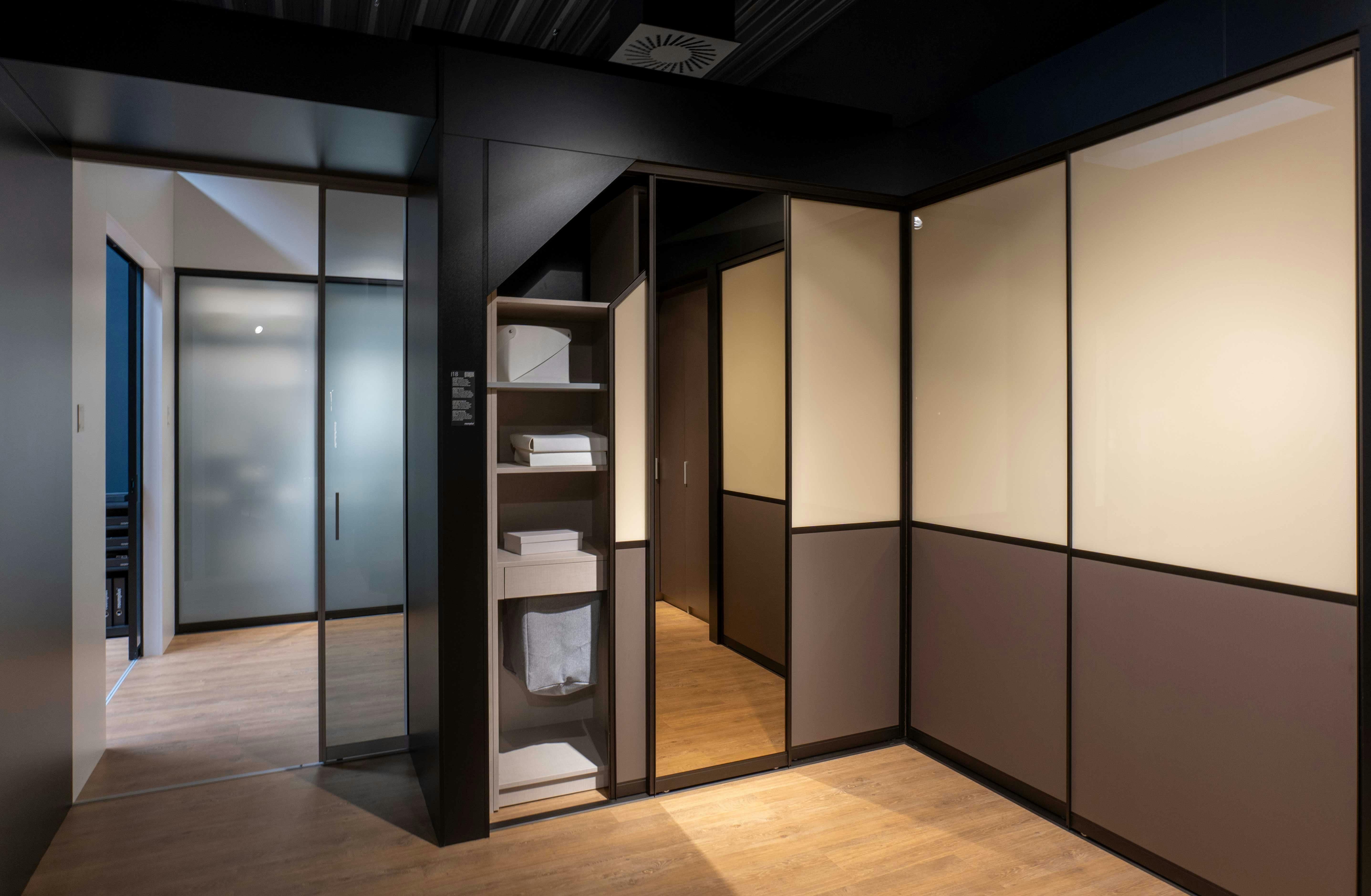 Person measuring a compact storage shelf in a small home space in Bandra, Mumbai, India