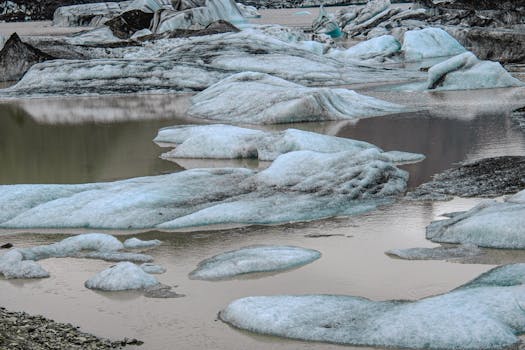 Majestic icebergs from Jökulsárlón glacier lagoon reflecting in calm waters, Iceland.