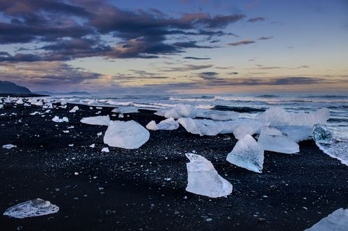 Free Ice formations on the black sand beach of Jökulsárlón, Iceland at sunset. Stock Photo