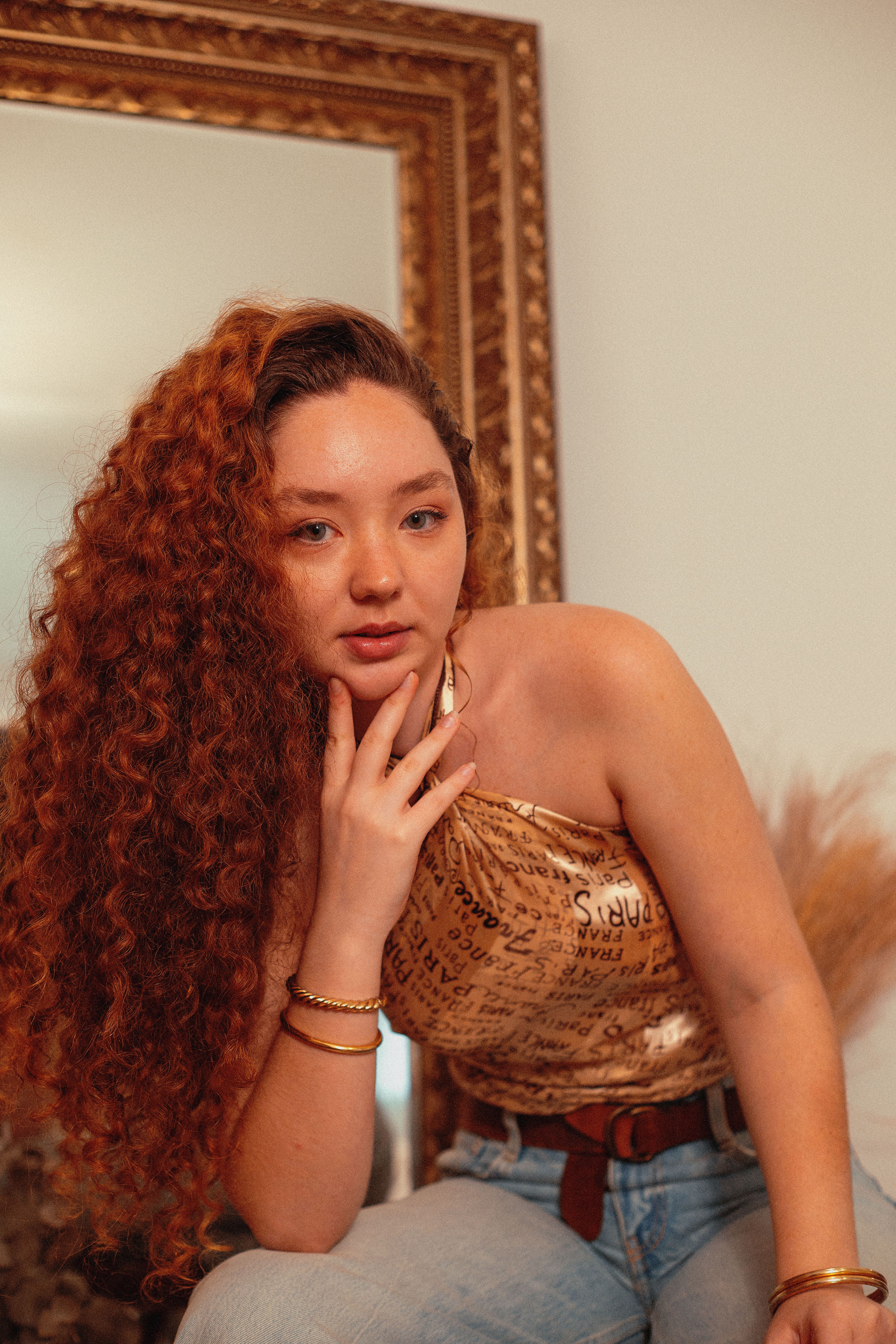 Stylish Young Woman with Curly Hair Indoors · Free Stock Photo