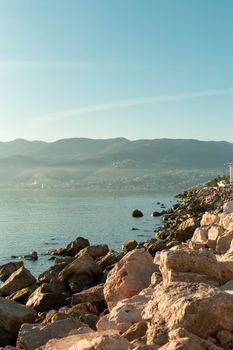 Beautiful rocky coastline in Croatia with Adriatic Sea and distant mountains.