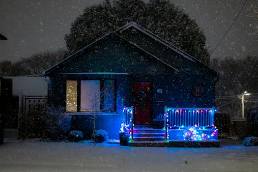 A cozy Toronto house decorated with Christmas lights during a snowy winter night.