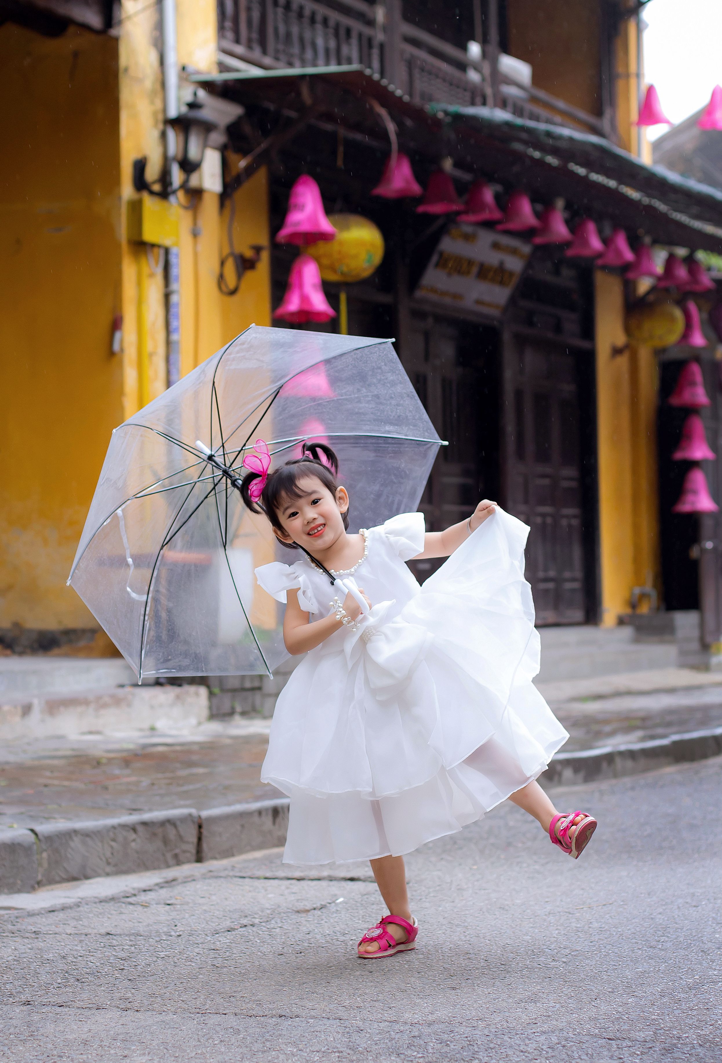 Cheerful Girl in White Dress with Umbrella in Hoi An · Free Stock Photo