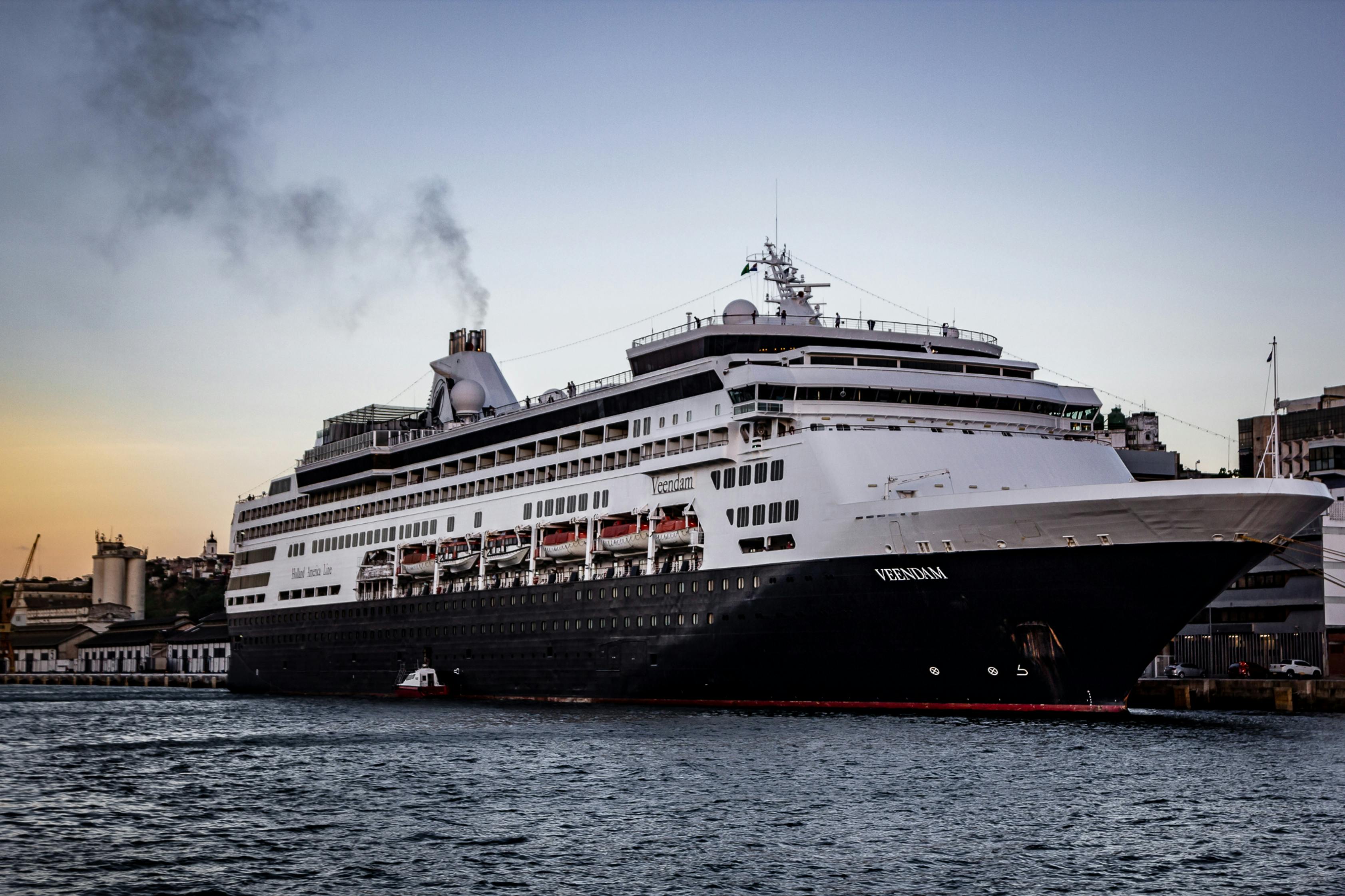 Disney Adventure cruise ship docked at Marina Bay Cruise Centre in Singapore with the city skyline in the background