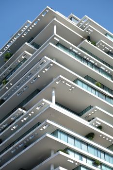 Close-up view of a modern apartment building with geometric architecture and balconies.