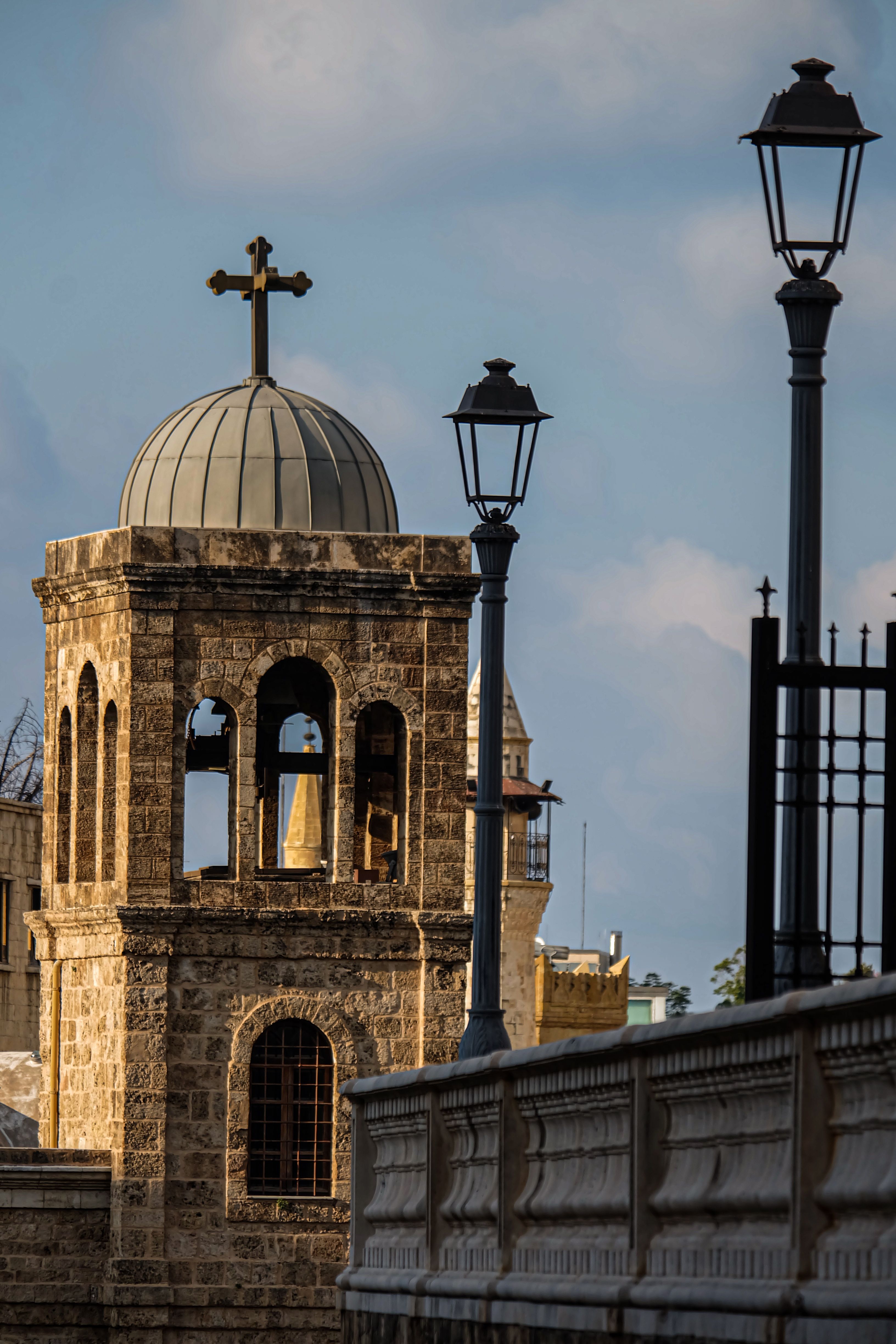 Historic Stone Church Tower with Cross at Dusk · Free Stock Photo