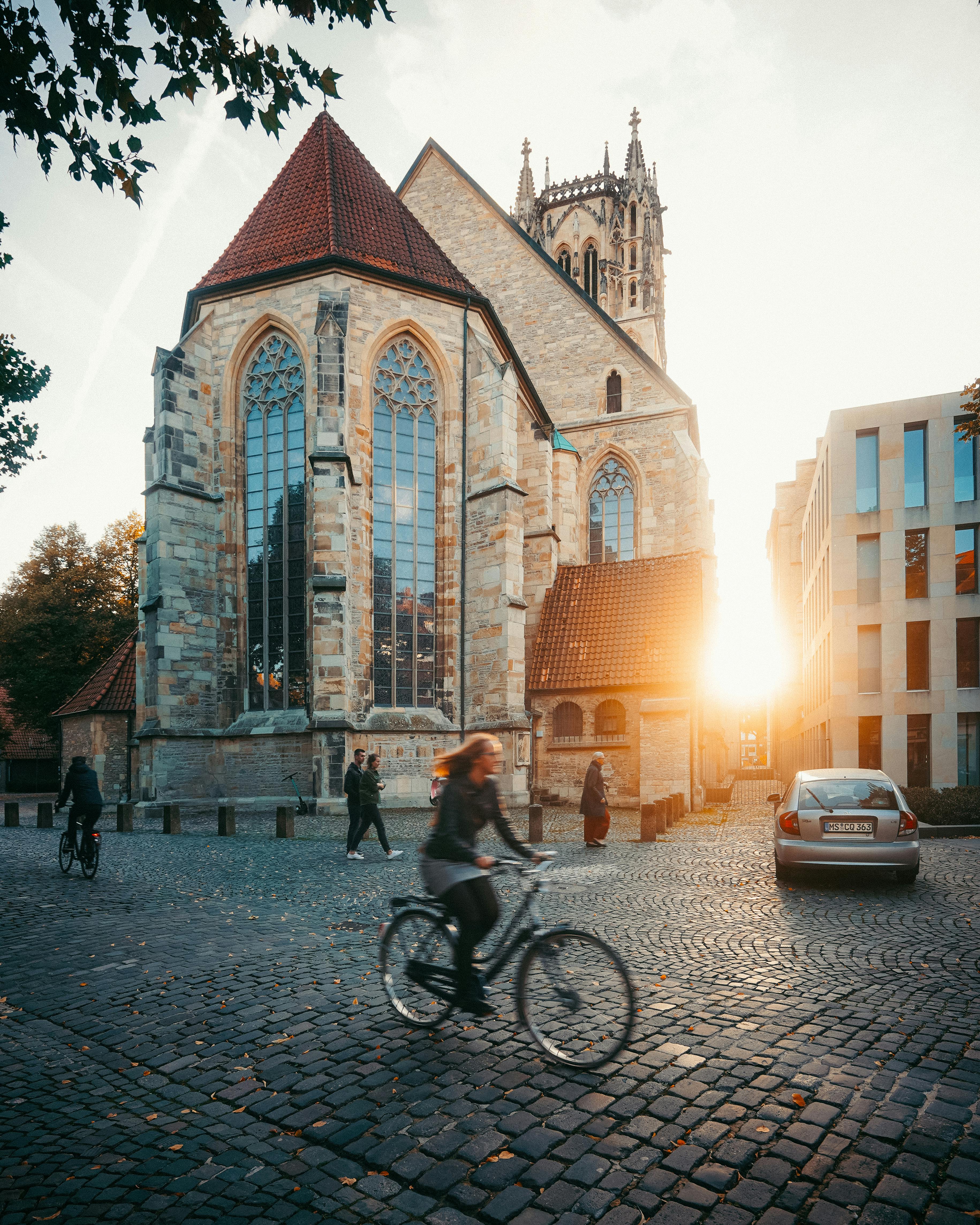 Woman Riding on Bike Outside Buildings