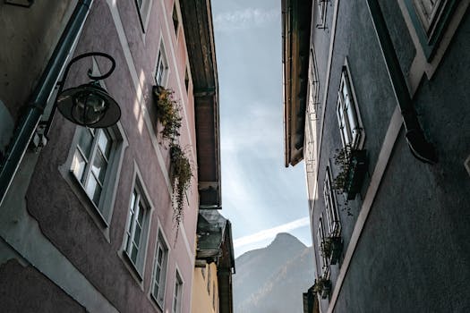 A scenic view between two classic buildings toward a mountain peak.