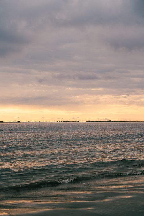Free Peaceful view of a sunset over the Caspian Sea in Baku, Azerbaijan, capturing the soothing sky and ocean waves. Stock Photo