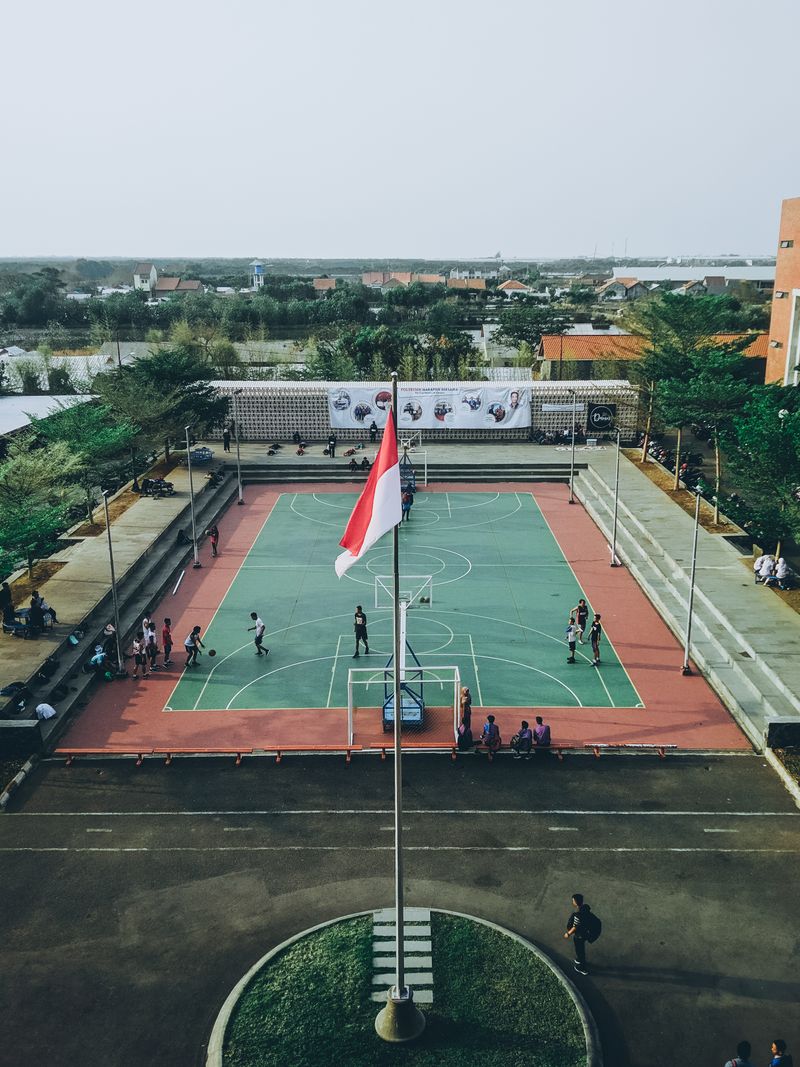 Aerial view of students playing basketball on an outdoor court