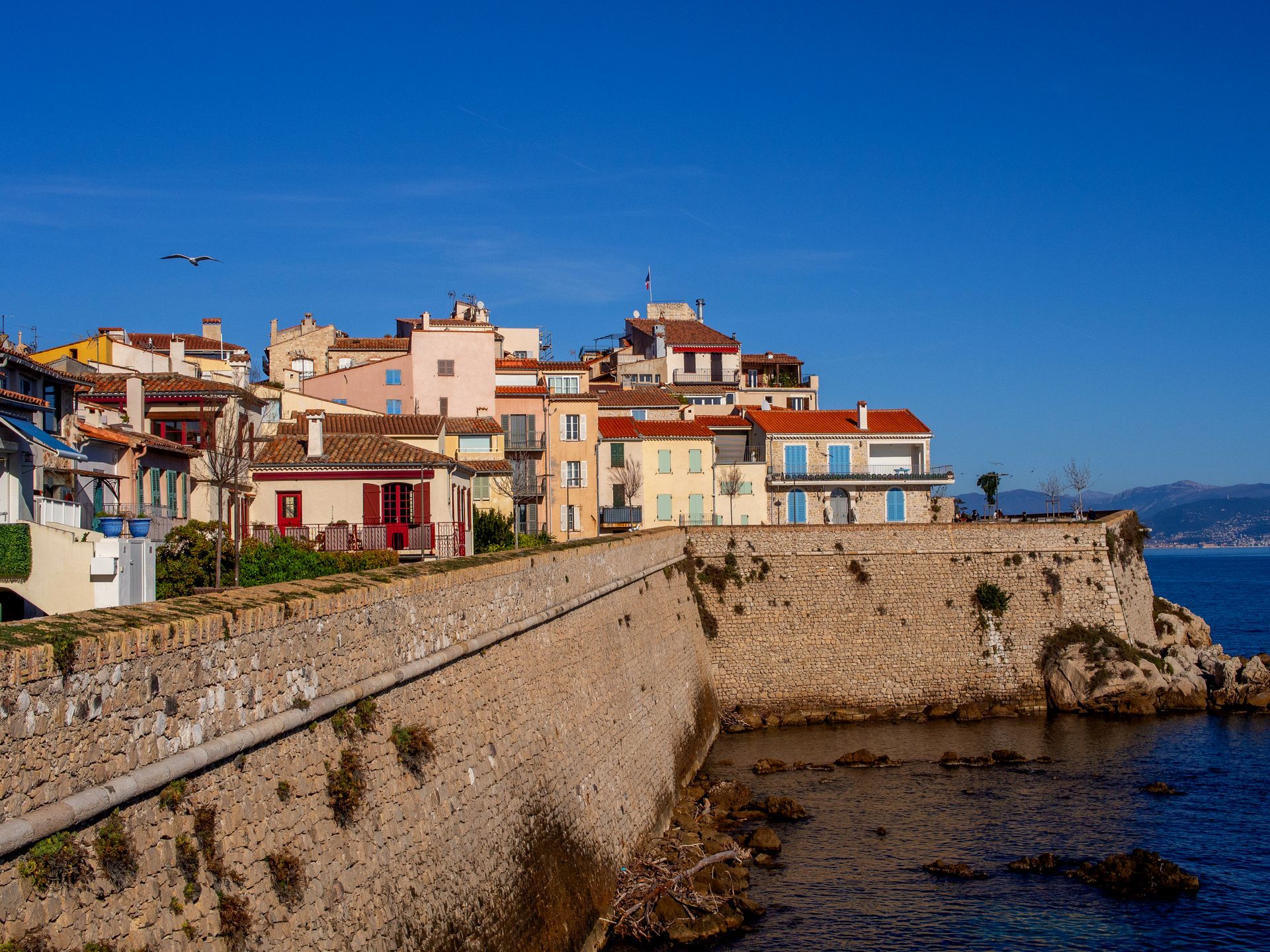 Colorful coastal buildings in the French village of Antibes on a sunny day.