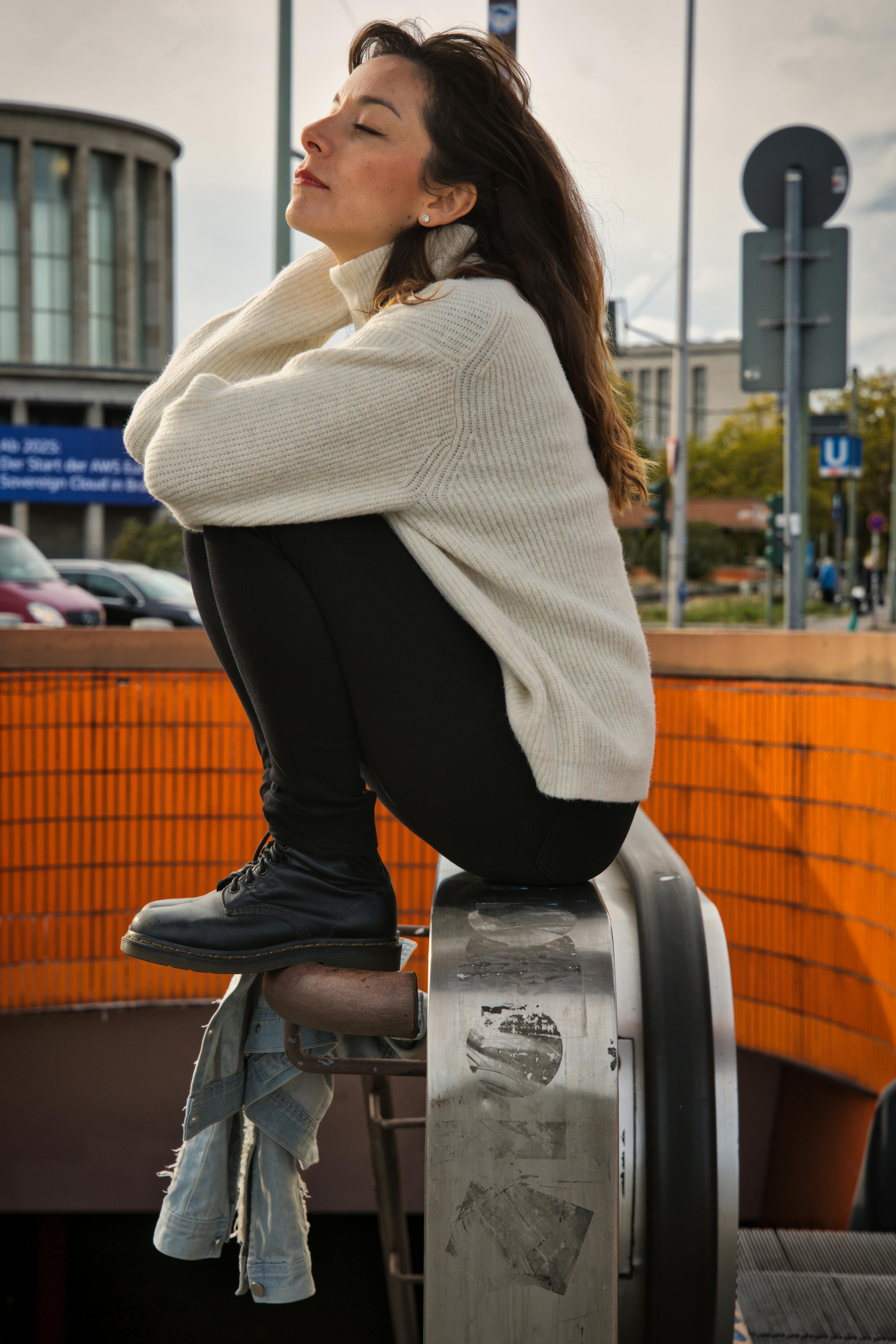 relaxed woman sitting outside in urban berlin