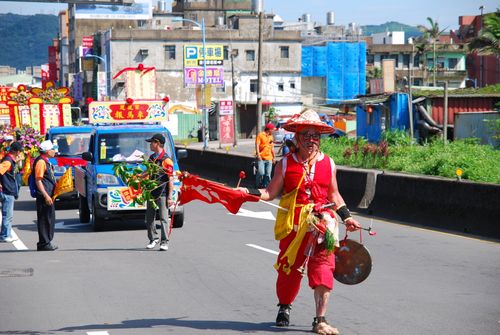 Free A lively cultural parade with colorful costumes and decorated vehicles in a city street. Stock Photo
