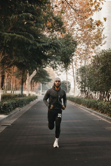 Athletic man jogging on a scenic path in Abuja, Nigeria.