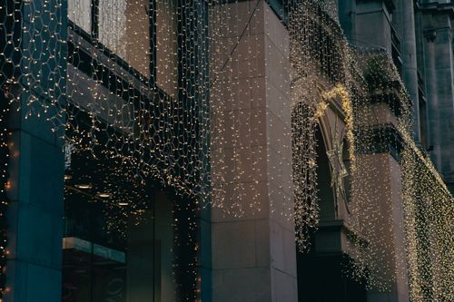Free Warm festive lights decorating a city's building facade during the holiday season in Antwerp. Stock Photo