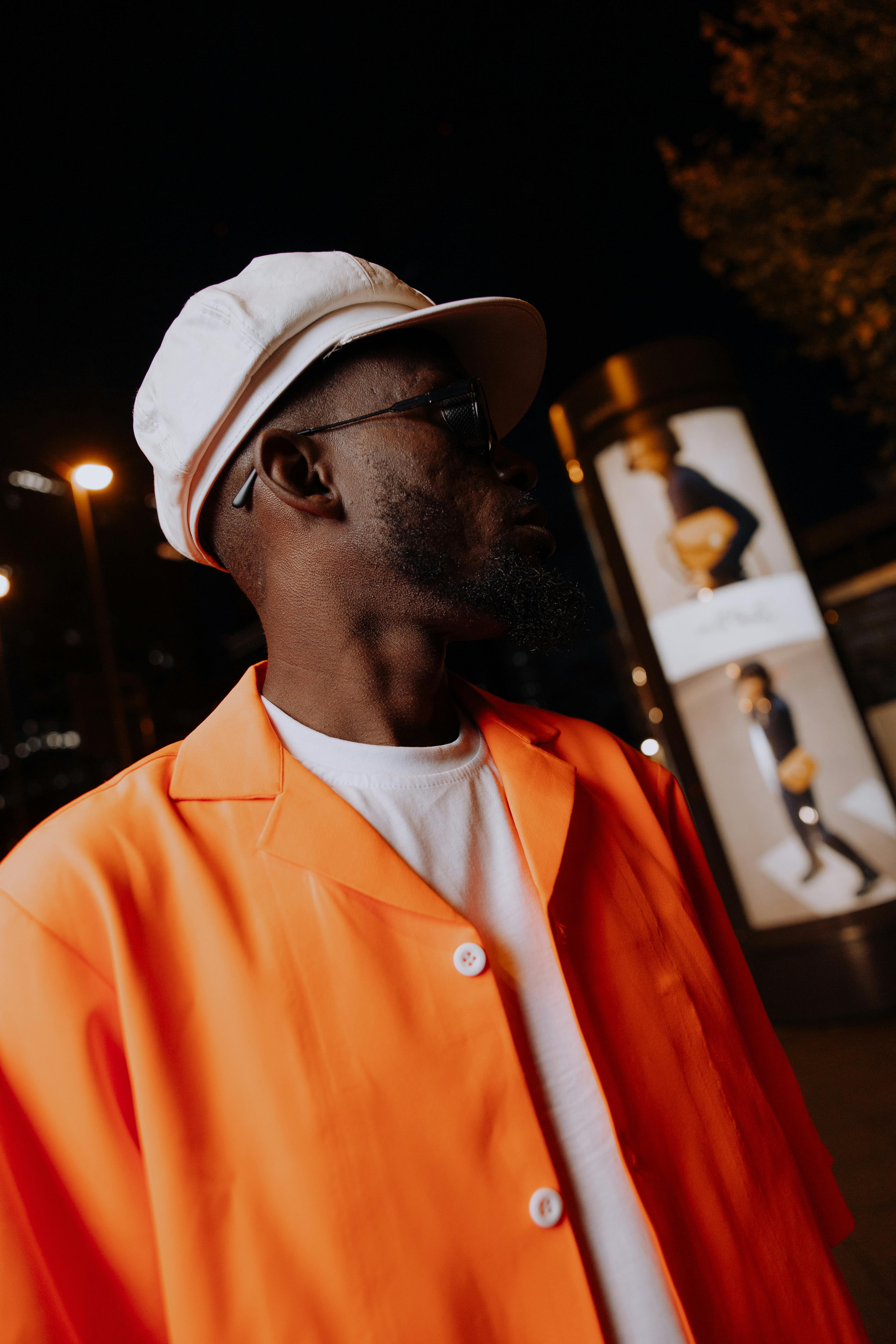 stylish man in orange jacket at night in frankfurt