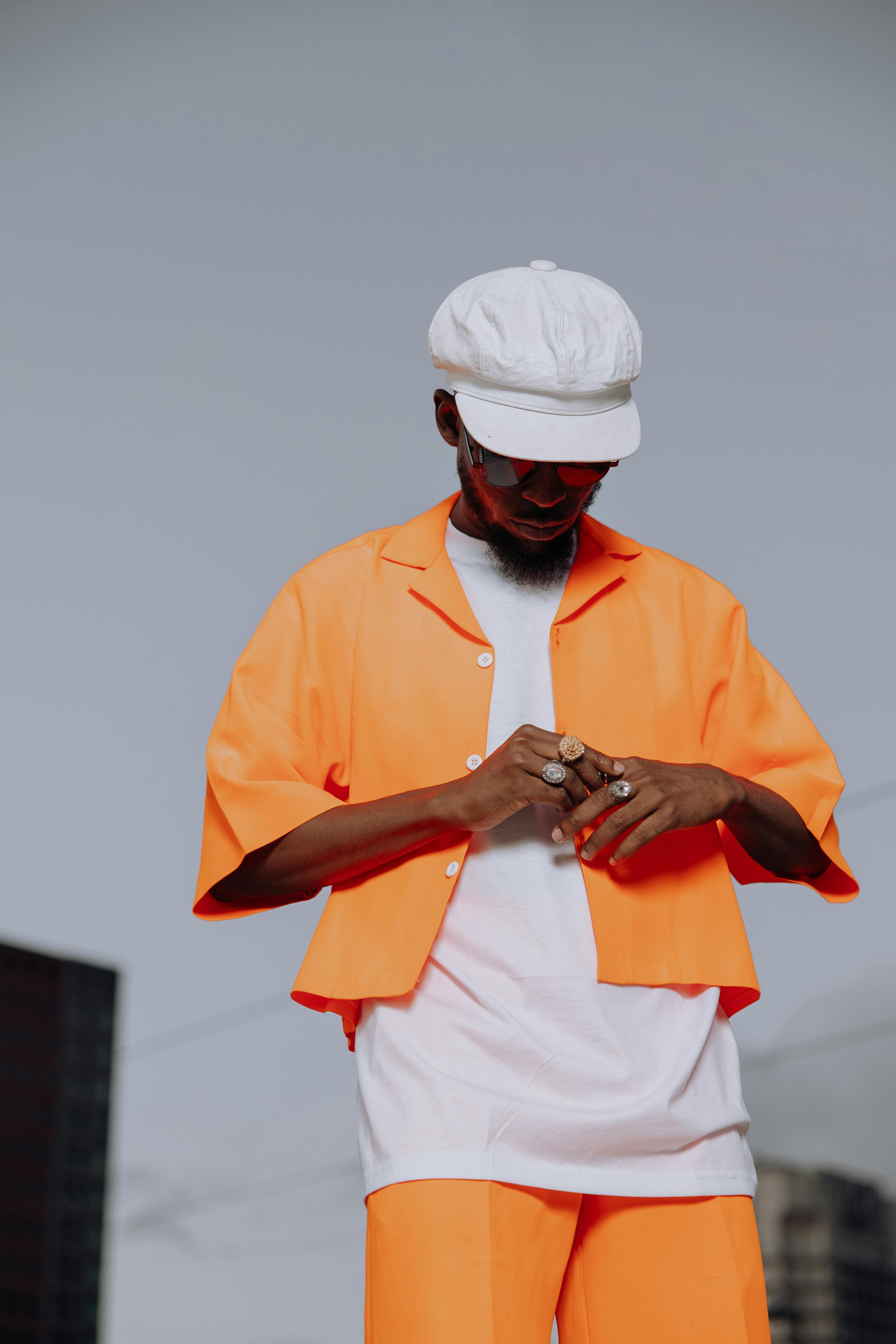 stylish man in orange outfit outdoors in frankfurt