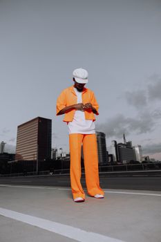 Person in bright outfit standing on a rooftop with Frankfurt skyscrapers in the background.