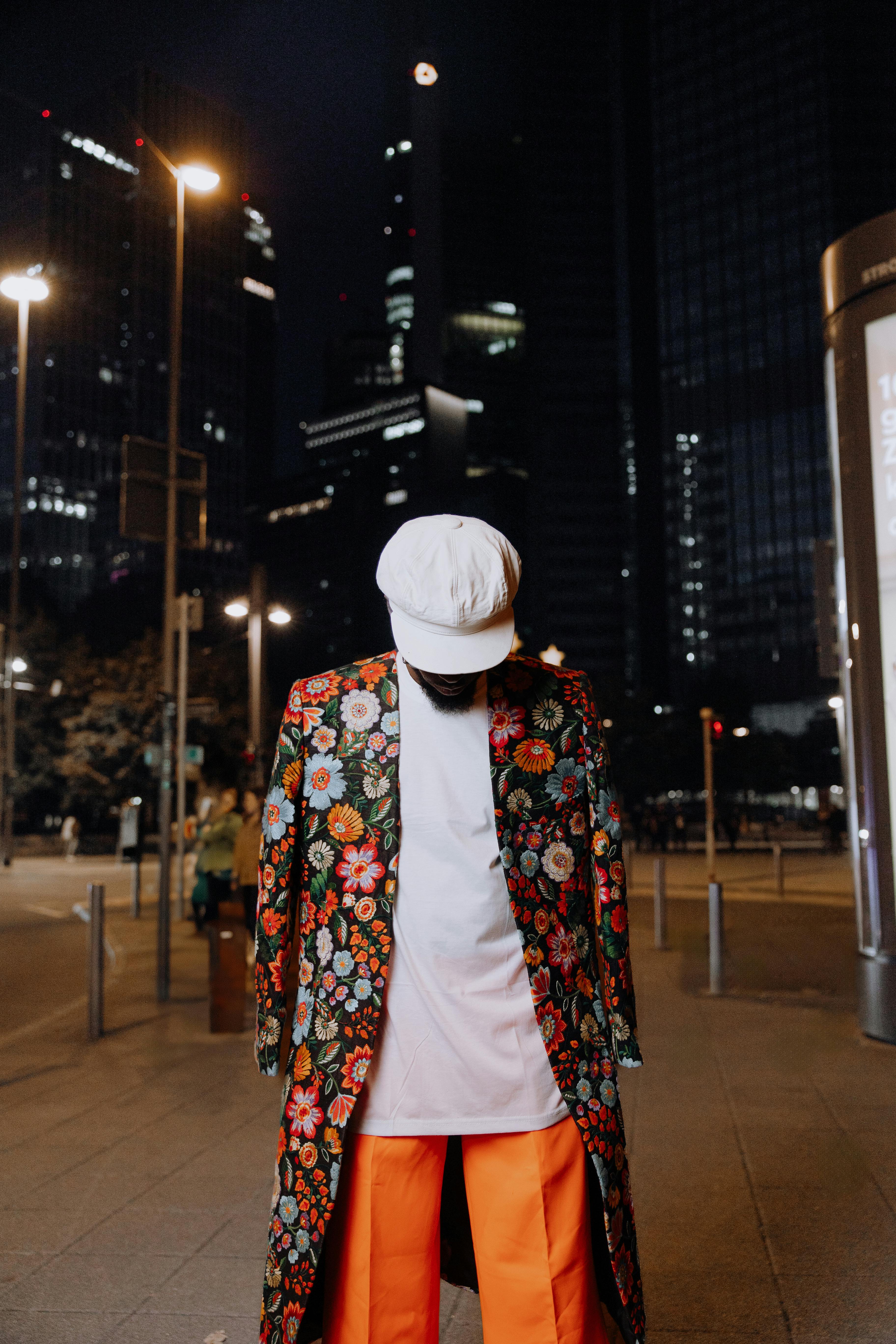 fashionable individual in floral coat at night in frankfurt