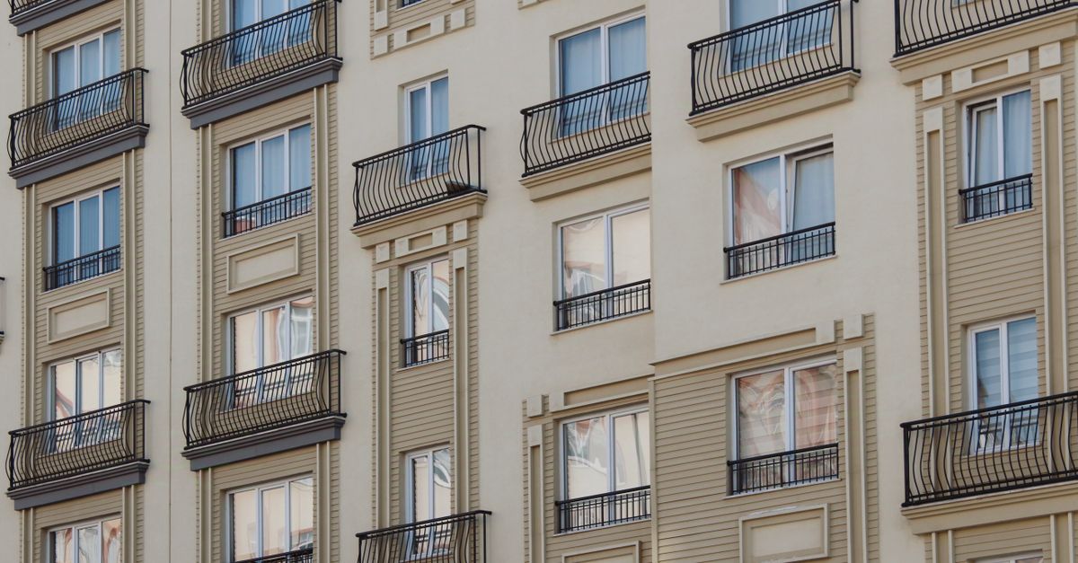 Close-up of a modern residential building facade with balconies and windows.