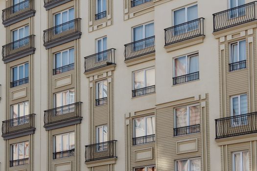 Close-up of a modern residential building facade with balconies and windows.