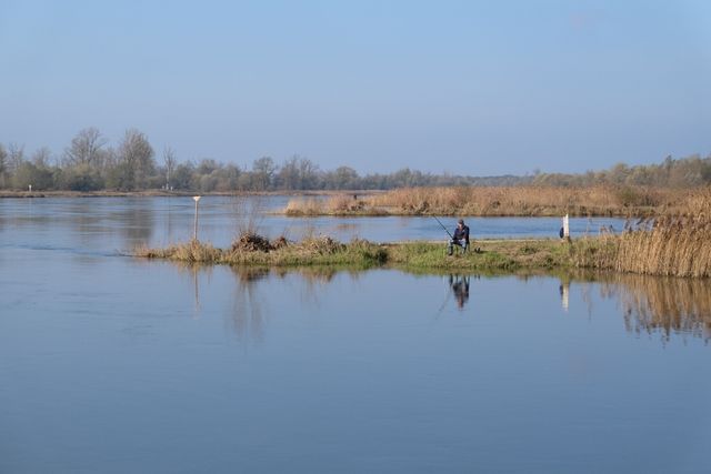 Anglers spread across a calm lake at first light