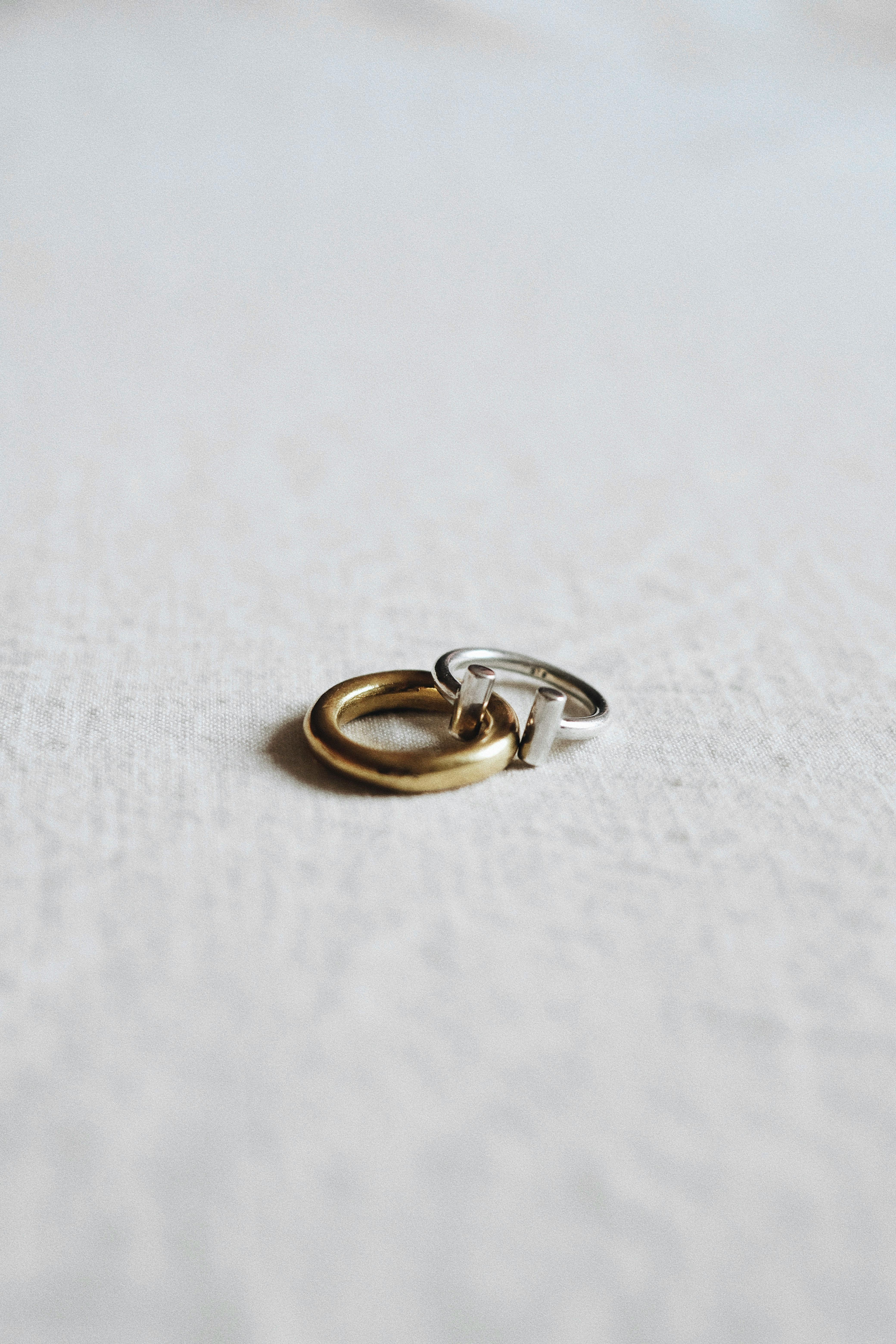 minimalist photograph of interlocking rings on fabric